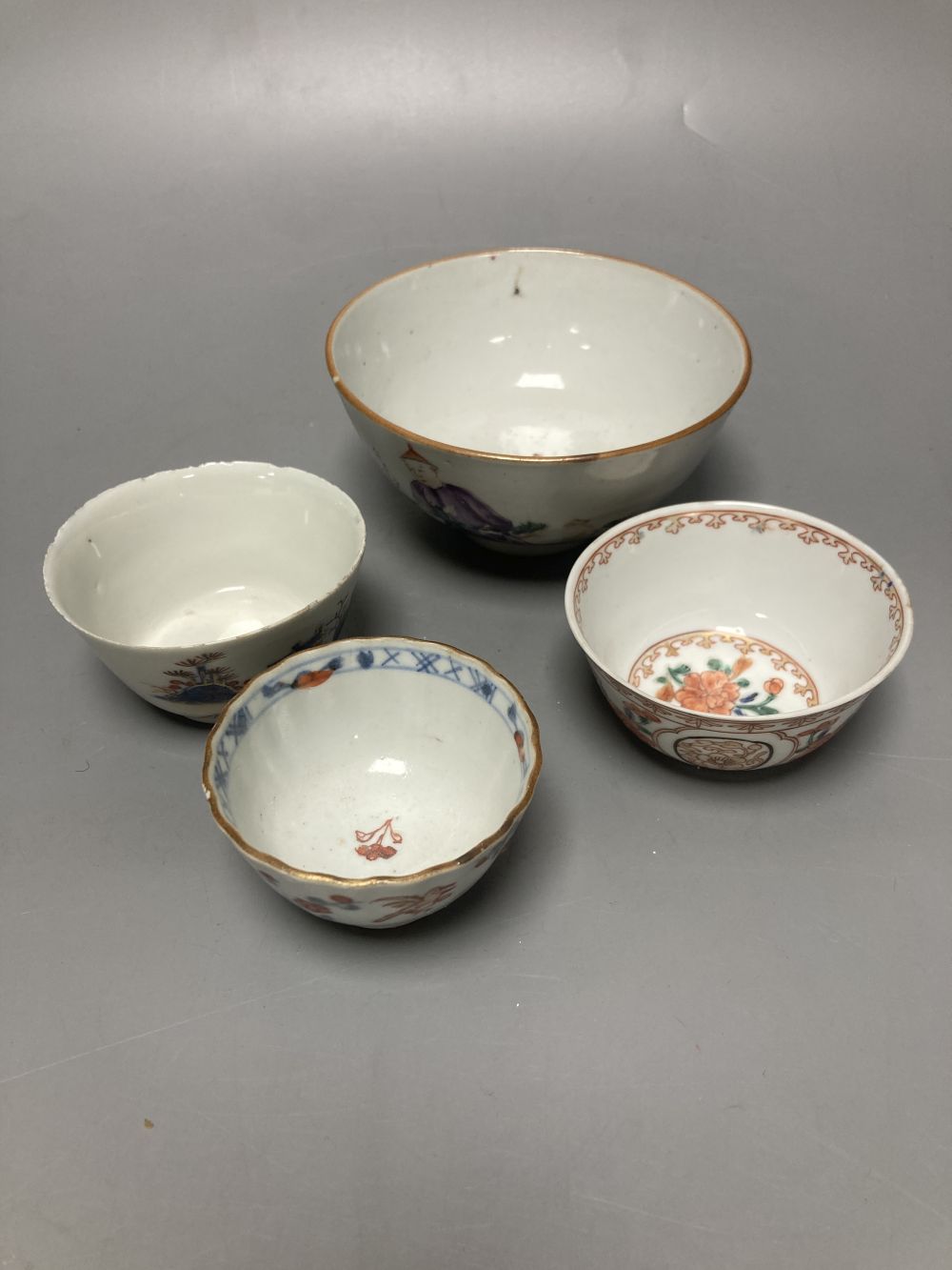 An 18th century Chinese famille rose bowl, 11.5cm diameter, and three smaller Chinese porcelain bowls